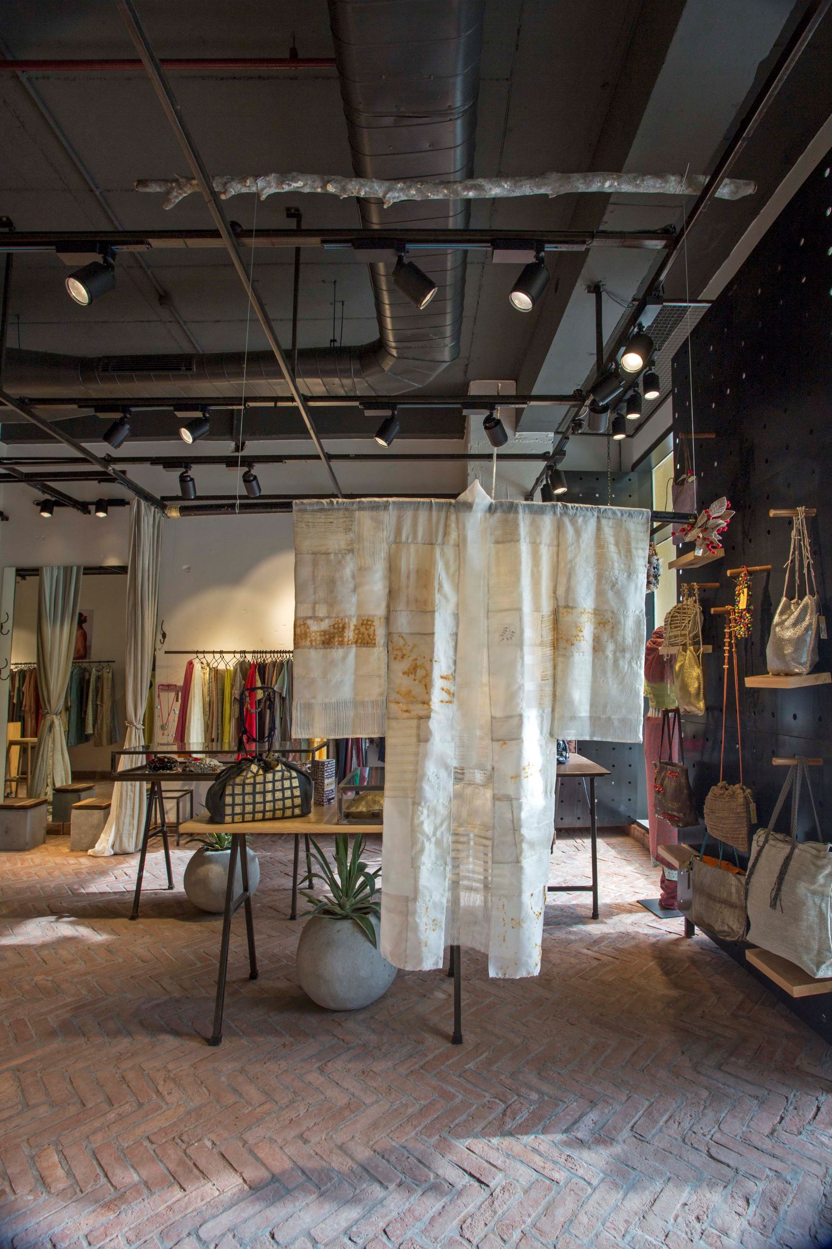 Art in fashion: A translucent, handcrafted kimono takes center stage, floating effortlessly within the industrial-chic volume of the store.
