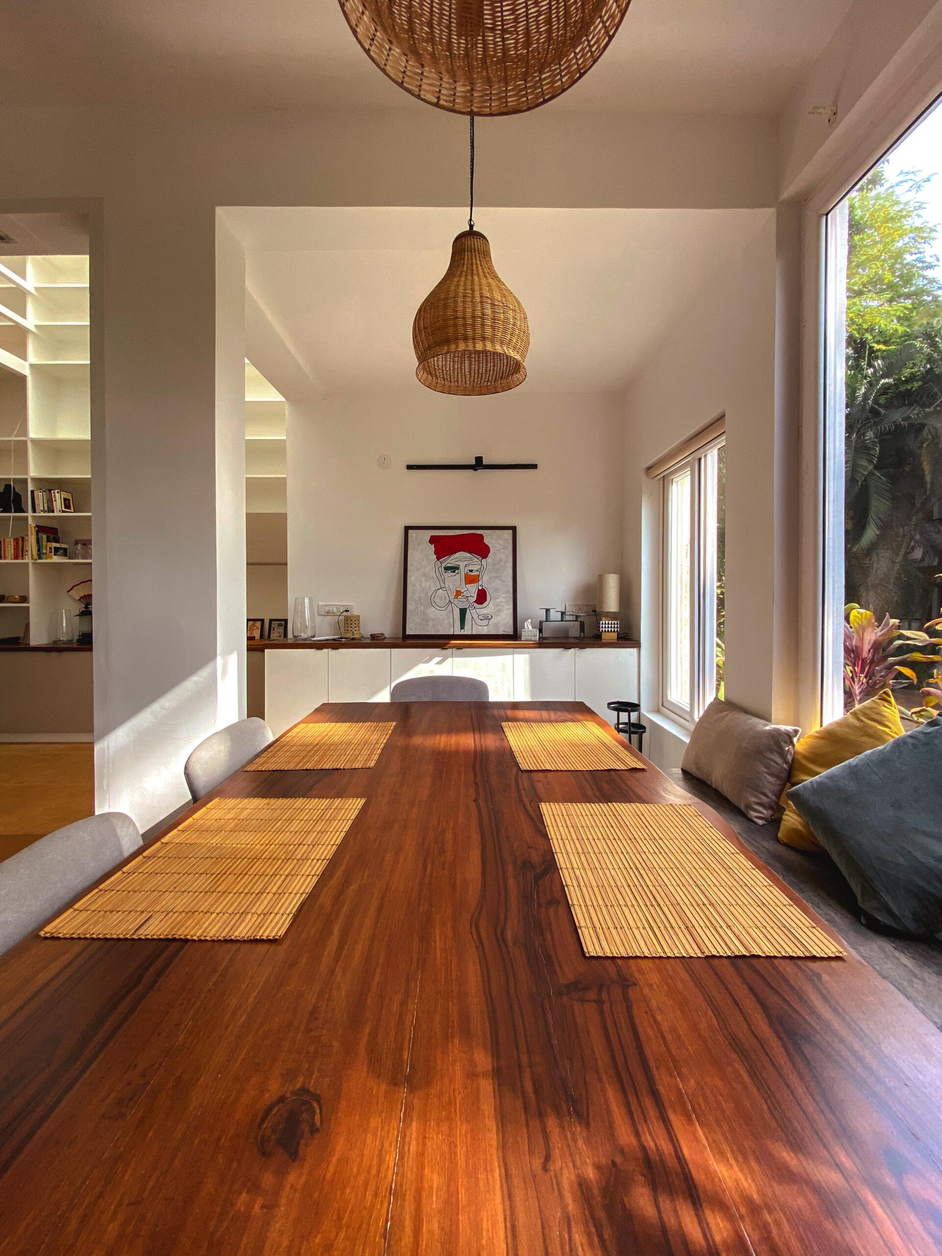 Curated comfort: The dining area blends rustic warmth with modern art, highlighted by a statement woven pendant light.